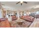 Open concept living room featuring hardwood floors, ceiling fan, island kitchen, a rug, and natural light at 4820 Se Clifftop Dr, Pahrump, NV 89061
