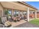 Covered patio featuring an outdoor dining table and comfortable outdoor seating at 4820 Se Clifftop Dr, Pahrump, NV 89061