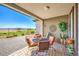 Covered patio featuring an outdoor dining table and views of the mountains and golf course at 4820 Se Clifftop Dr, Pahrump, NV 89061