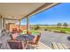 Covered patio featuring an outdoor dining table and beautiful views of the golf course at 4820 Se Clifftop Dr, Pahrump, NV 89061