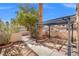 Enclosed backyard with stone tile patio and pergola, featuring desert landscaping at 51 Belle Point Ave, Las Vegas, NV 89123