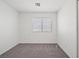 Minimalist bedroom with neutral carpet and natural light at 51 Belle Point Ave, Las Vegas, NV 89123