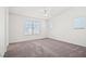 Spacious, bright bedroom with neutral carpet and multiple windows at 51 Belle Point Ave, Las Vegas, NV 89123