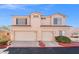 Charming two-story home featuring a tile roof, desert landscaping, and two-car garage at 51 Belle Point Ave, Las Vegas, NV 89123