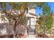 Charming home featuring a tile roof, desert landscaping, and gated courtyard at 51 Belle Point Ave, Las Vegas, NV 89123