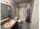 Bathroom showcasing a granite countertop vanity, mirror, and shower with tub and toilet at 5150 S Jones Blvd # 105, Las Vegas, NV 89118