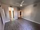 Spacious bedroom featuring ceiling fan, wood-look flooring, and access to closet and bathroom at 5150 S Jones Blvd # 105, Las Vegas, NV 89118