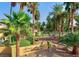 Well-maintained community entrance with lush landscaping and mature palm trees at 5150 S Jones Blvd # 105, Las Vegas, NV 89118