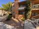 Condominium exterior with desert landscaping, stairs, and upper balcony at 5150 S Jones Blvd # 105, Las Vegas, NV 89118