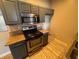 Updated kitchen features stainless steel appliances, granite countertops, and grey cabinetry at 5150 S Jones Blvd # 105, Las Vegas, NV 89118