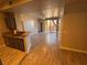 Living room features wood floors, neutral walls, kitchen bar, and sliding glass doors at 5150 S Jones Blvd # 105, Las Vegas, NV 89118