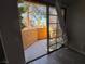 View of a small stucco patio with a glass sliding door and gray wood flooring at 5150 S Jones Blvd # 105, Las Vegas, NV 89118