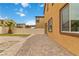 The backyard showcases a brick patio, artificial turf, and privacy fence, ideal for outdoor living at 5317 Golden Melody Ln, North Las Vegas, NV 89081
