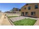 Backyard featuring artificial grass, a patio, and a privacy fence at 5317 Golden Melody Ln, North Las Vegas, NV 89081
