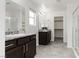 Bright bathroom features dual vanities with granite counters, tile flooring, and glass-enclosed shower at 5317 Golden Melody Ln, North Las Vegas, NV 89081