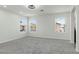 Spacious carpeted bedroom with ceiling fan and natural light from multiple windows at 5317 Golden Melody Ln, North Las Vegas, NV 89081