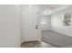 Inviting entryway with a white front door leading into a brightly lit, carpeted living space at 5317 Golden Melody Ln, North Las Vegas, NV 89081