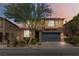 Charming two-story home with a well-manicured front yard, desert landscaping and a two-car garage at 5317 Golden Melody Ln, North Las Vegas, NV 89081