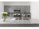 Well-equipped kitchen with granite countertops, stainless steel appliances, and grey cabinetry at 5317 Golden Melody Ln, North Las Vegas, NV 89081