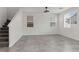 Bright and airy living room with tile flooring, large windows, and modern lighting fixture at 5317 Golden Melody Ln, North Las Vegas, NV 89081