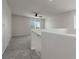Upstairs loft area with neutral carpet, fan, and natural light at 5317 Golden Melody Ln, North Las Vegas, NV 89081