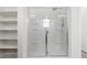 Modern shower with glass doors, built-in shelves, and sleek fixtures at 5317 Golden Melody Ln, North Las Vegas, NV 89081