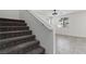 Carpeted staircase leads to the upper level, illuminated by natural light from nearby windows at 5317 Golden Melody Ln, North Las Vegas, NV 89081