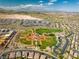 Wide aerial shot of baseball fields, park, and surrounding community with picturesque mountain views at 5594 Trilling Bird Dr, Las Vegas, NV 89135