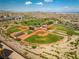 Aerial view highlighting baseball field, tennis courts, playground, landscaping, and surrounding community at 5594 Trilling Bird Dr, Las Vegas, NV 89135