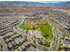 Community aerial view features a baseball field, tennis courts, playground, and surrounding neighborhood at 5594 Trilling Bird Dr, Las Vegas, NV 89135