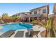 Resort style backyard with luxurious pool, spa, and outdoor kitchen perfect for entertaining at 5594 Trilling Bird Dr, Las Vegas, NV 89135