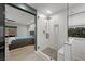 This modern bathroom features an all-glass shower and view of the backyard at 5594 Trilling Bird Dr, Las Vegas, NV 89135