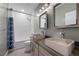 Bathroom featuring dual vessel sinks, modern lighting, and a tub with shower at 5594 Trilling Bird Dr, Las Vegas, NV 89135