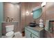 Vibrant powder room showcasing decorative wallpaper, vessel sink, and modern fixtures at 5594 Trilling Bird Dr, Las Vegas, NV 89135