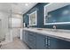 Modern bathroom featuring double sinks, illuminated mirrors, and glass shower at 5594 Trilling Bird Dr, Las Vegas, NV 89135