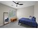 Neutral toned bedroom with a full-length mirror and a window with shutters at 5594 Trilling Bird Dr, Las Vegas, NV 89135