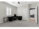 Multipurpose bedroom featuring neutral walls, a full office setup and a doorway to another bedroom at 5594 Trilling Bird Dr, Las Vegas, NV 89135