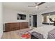 Bright bedroom featuring modern ceiling fan, dresser, and outdoor access through a sliding glass door at 5594 Trilling Bird Dr, Las Vegas, NV 89135