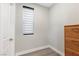 Cozy bedroom featuring a window with blinds, light walls and wood-style flooring at 5594 Trilling Bird Dr, Las Vegas, NV 89135