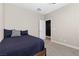 Neutral bedroom with large bed, gray carpet and modern fixtures provide a calm and peaceful retreat at 5594 Trilling Bird Dr, Las Vegas, NV 89135