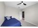 Bedroom featuring a ceiling fan and access to an adjacent bathroom at 5594 Trilling Bird Dr, Las Vegas, NV 89135