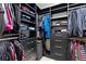 Walk-in closet with ample storage, black shelves, drawers, and clothing racks for organized storage at 5594 Trilling Bird Dr, Las Vegas, NV 89135