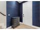 Stylish entryway featuring a white front door, modern console table, and elegant blue textured wallpaper at 5594 Trilling Bird Dr, Las Vegas, NV 89135