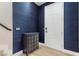 Elegant entryway with textured blue wallpaper, wood floors, and a decorative console table near the front door at 5594 Trilling Bird Dr, Las Vegas, NV 89135