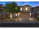 Charming two-story home boasts a well-manicured front yard and inviting curb appeal with a two-car garage at 5594 Trilling Bird Dr, Las Vegas, NV 89135