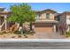 Daytime view of a two-story home boasting a well-manicured front yard and inviting curb appeal at 5594 Trilling Bird Dr, Las Vegas, NV 89135