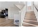Bright foyer with wooden staircase and modern finishes, creating a welcoming entrance at 5594 Trilling Bird Dr, Las Vegas, NV 89135