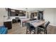 Bright kitchen featuring an island with seating and an adjacent dining area at 5594 Trilling Bird Dr, Las Vegas, NV 89135