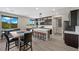 Modern kitchen with dark wood cabinets, large island, and stainless steel appliances at 5594 Trilling Bird Dr, Las Vegas, NV 89135