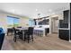 Modern kitchen with stainless steel appliances, a breakfast bar, and stylish dark wood cabinetry with light countertops at 5594 Trilling Bird Dr, Las Vegas, NV 89135